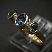 Ring 585/- Gelbgold mit 1 Tansanit 2 Blautopase und 8 Diamanten